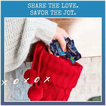 Share the Love, Savor the Joy. Chocolove Peppermint Creme in Dark Chocolate Tree-Shaped Holiday Bites in a stocking hung on a mantle