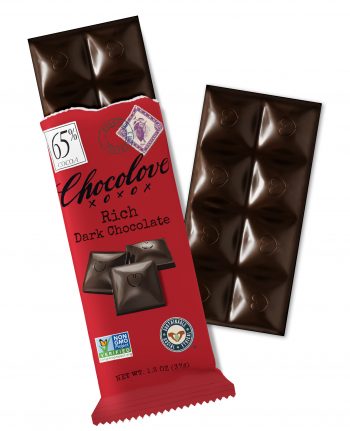 A Chocolove Peppermint in Dark Chocolate mini bar is partially unwrapped, revealing dark chocolate squares with embossed heart designs. The wrapper is a cool, pastel blue with an elegant, vintage-inspired design. It features an image of fresh peppermint leaves, emphasizing the refreshing minty contrast against the rich dark chocolate. A 55% cocoa label is displayed in the top left corner, with a stamp-style illustration of peppermint and a blue Belgian Chocolate seal near the top. The glossy chocolate surface highlights its premium Belgian quality.