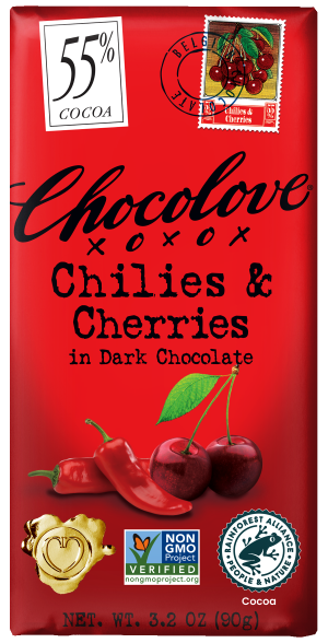 Front of a Chocolove Chilies & Cherries in Dark Chocolate bar wrapper. The background is a vibrant red with the product name "Chilies & Cherries in Dark Chocolate" displayed in bold black letters. The top left corner features a stamp with the percentage "55%" and the words "Cocoa Content," along with a small illustration of cherries. The wrapper also includes logos for Non-GMO Project Verified and Rainforest Alliance Certified, with a heart-shaped seal at the bottom.