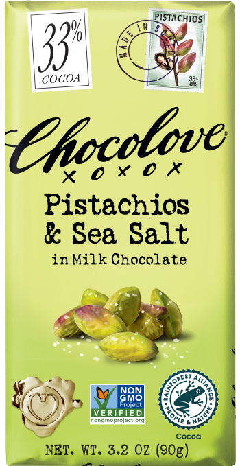 A Chocolove chocolate bar with a light green wrapper. The packaging displays '33% Cocoa' in a white box, a stamp illustration of pistachios, and bold black lettering that states 'Pistachios & Sea Salt in Milk Chocolate.' Below, an image of shelled pistachios with sea salt is featured. The bar carries Non-GMO Project Verified and Rainforest Alliance Certified labels.