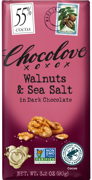 A Chocolove chocolate bar with a pinkish-purple wrapper. The packaging features '55% Cocoa' in a white box, a stamp illustration of walnuts, and bold black lettering reading 'Walnuts & Sea Salt in Dark Chocolate.' Below, an image of walnuts sprinkled with sea salt is displayed. The bar is labeled Non-GMO Project Verified and Rainforest Alliance Certified.