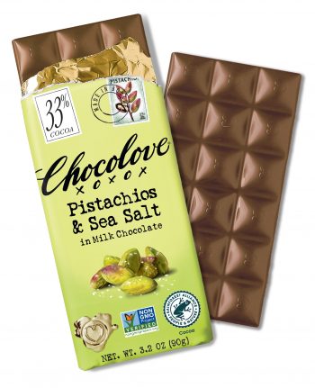 Chocolove Pistachios & Sea Salt in Milk Chocolate bar (33% cocoa) partially unwrapped, revealing smooth milk chocolate with a glossy finish. The packaging features pistachios with sea salt, a gold foil wrapper, and certification logos, including Non-GMO Project Verified and Rainforest Alliance Certified