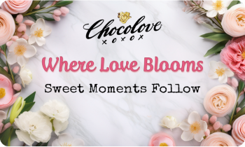 Chocolove Digital Gift Card featuring a frame of springtime flowers on a white marble background, with words that say "Where Love Blooms, Sweet Moments Follow"