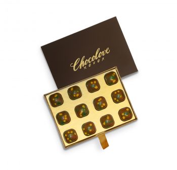 Top-down view of Chocolove Dubai Style Pistachio & Kadayif Milk Chocolate Gift Box with open gold tray and closed brown lid featuring Chocolove branding