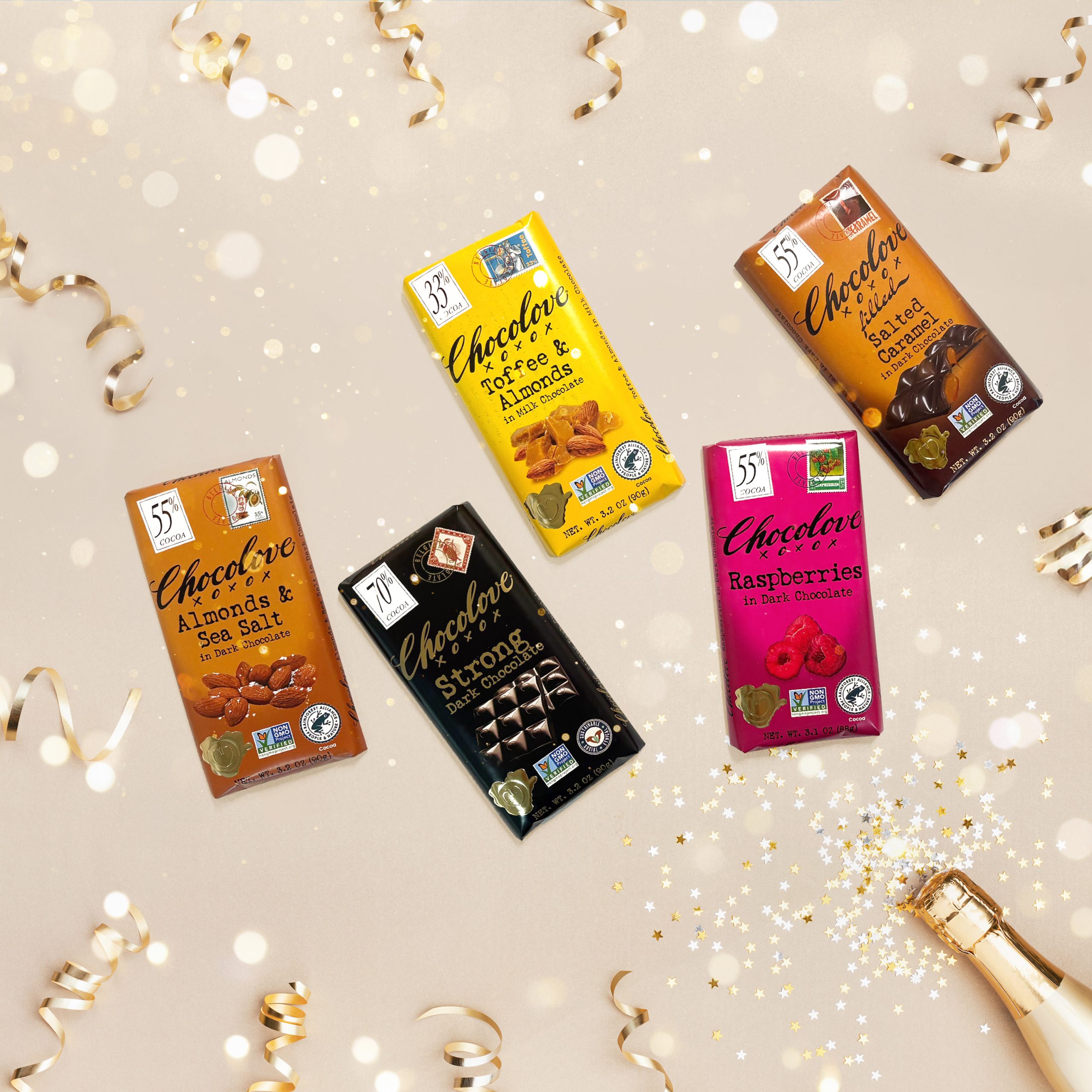 Chocolove celebrating 30 years, Celebratory image with champagne, assorted chocolate bars and confetti.