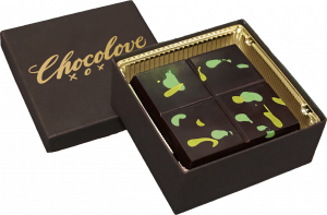 Chocolove Midnight Dark Chocolate Pistachio Luxe Bar in open gift box with green pistachio-inspired design on dark chocolate squares.