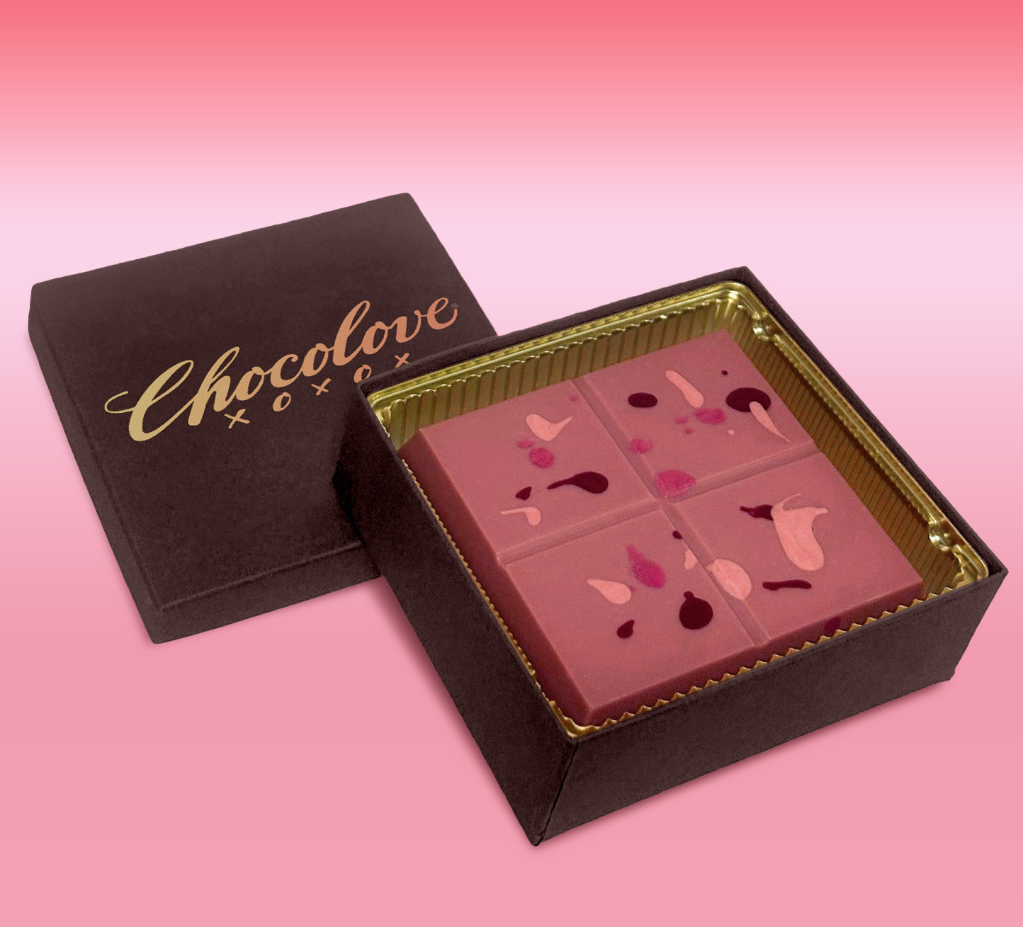 Chocolove Sunburst Mango-Passion Fruit Ruby Chocolate Luxe Bar in open gold-lined gift box with pink chocolate squares.