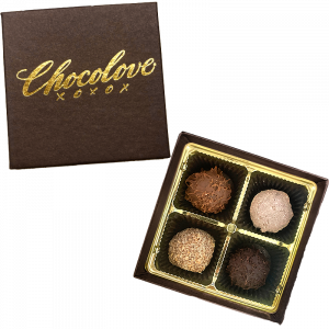 Handcrafted 4-piece Chocolove truffle assortment in luxury gift box. Luxury 4-piece artisanal truffle assortment in elegant Chocolove gift packaging